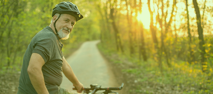 Man smiling on a bike